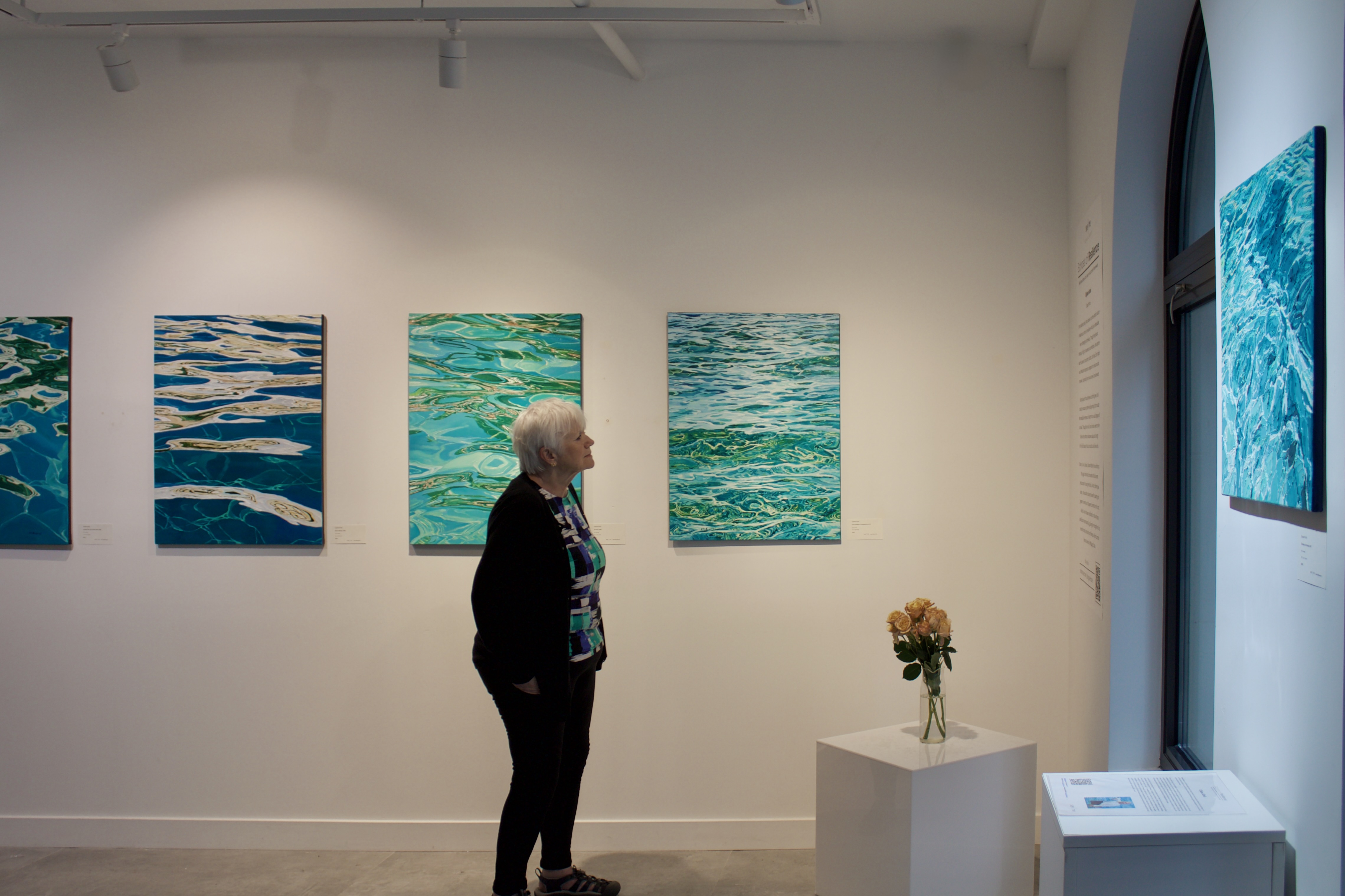 Visitor viewing artwork in a gallery exhibition